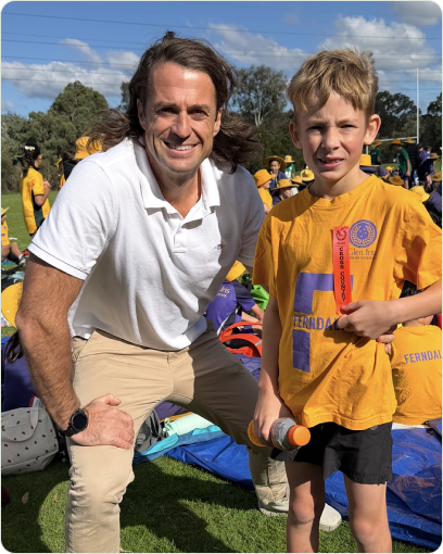 Dr Robbie Hunt, founder of Wellbeing Chiropractic, with one of his sons at a school cross-country event.