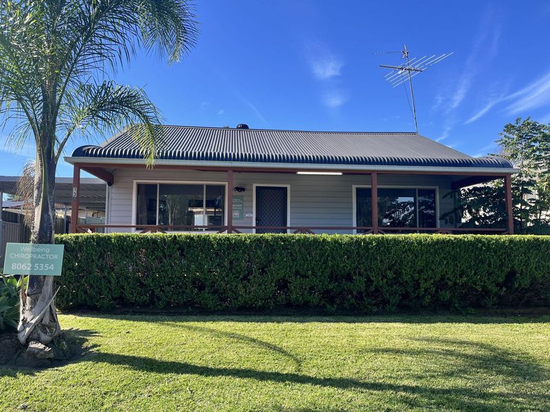 Exterior of Wellbeing Chiropractic Schofields with a palm tree and front lawn Exterior of Wellbeing Chiropractic Schofields with a palm tree and front lawn